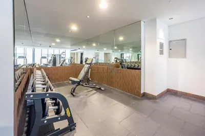 a salon with a row of chairs and a mirror at Tranquil Studio Just minutes Drive to Dubai Attraction, O10 Building Al Jaddaf by Deluxe Holiday Homes in Dubai
