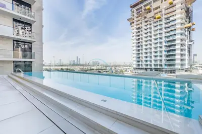 a swimming pool on the roof of a building at Tranquil Studio Just minutes Drive to Dubai Attraction, O10 Building Al Jaddaf by Deluxe Holiday Homes in Dubai