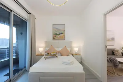 a bedroom with a bed and a mirror at Casa Aruri,1B Marina Escape Near Metro and Marina Mall in Dubai