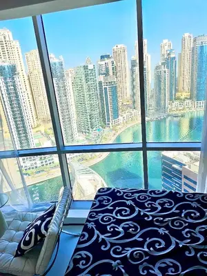 a bedroom with a view of the city from a window at Vip guestroom 360 view of marina private terrace with pool in Dubai