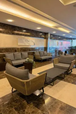 a lobby with chairs and couches in a building at High-Floor Marina 1BR Apartment | Skyline Views in Dubai