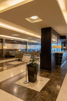 a lobby with a couch and a table in a building at High-Floor Marina 1BR Apartment | Skyline Views in Dubai