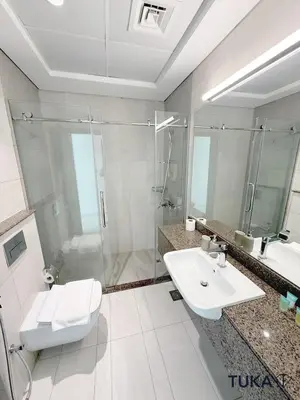 a bathroom with a toilet and a sink and a shower at 1-BHK - Brand New Building - Spacious - Central in Dubai