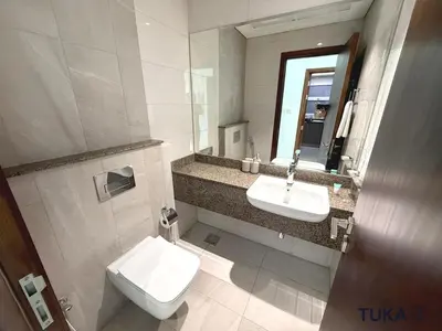 a bathroom with a toilet and a sink and a mirror at 1-BHK - Brand New Building - Spacious - Central in Dubai