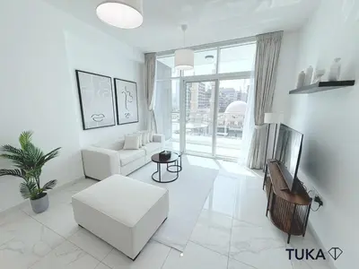 a living room with white furniture and a large window at 1-BHK - Brand New Building - Spacious - Central in Dubai