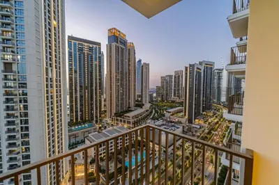 a balcony view of a city with tall buildings at 1BR Burj View Apartment In Dubai Creek Harbour in Dubai
