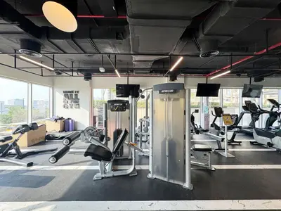 a gym with several treadmills and cardio machines at Smart & Elegant 2BR in Collective Dubai Hills in Dubai