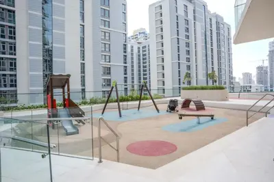 a playground in a building with tall buildings at Premium 1BR in JVC with Private Pool in Dubai