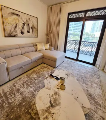 a living room with a couch and a table at Yansoon 3 Downtown, Dubai in Dubai