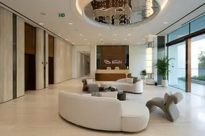 a living room with a white couch and chairs at Chic & Peaceful Studio Retreat Binghatti Aurora in Dubai