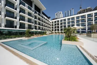 a swimming pool in front of a building at Chic & Peaceful Studio Retreat Binghatti Aurora in Dubai