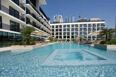 a large swimming pool in front of a building at Chic & Peaceful Studio Retreat Binghatti Aurora in Dubai