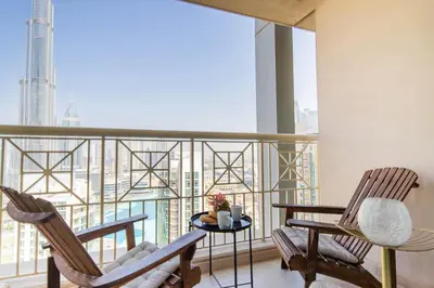 two chairs and a table on a balcony with a view at Frank Porter - 29 Boulevard Tower 2 in Dubai