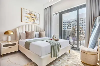 a white bedroom with a bed and a balcony at Frank Porter - Azizi Beach Mirage in Dubai