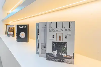 a wall with a sign that reads sale and a magazine at Escape24 Upgraded 1BR Al Bahar with Partial Burj & Fountain View in Dubai