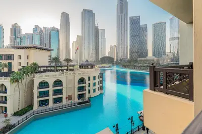 a view of a river in a city with tall buildings at Escape24 Upgraded 1BR Al Bahar with Partial Burj & Fountain View in Dubai