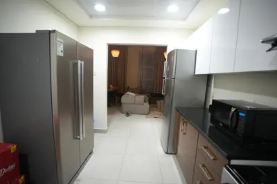 a kitchen with a refrigerator and a microwave at Marina bedspace Partial Sea View close to Tram in Dubai