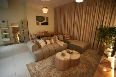a living room with a couch and a coffee table at Marina bedspace Partial Sea View close to Tram in Dubai
