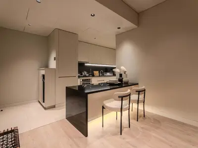 a kitchen with a counter and stools in a room at Quiet Luxury and Views at The Address Dubai Marina in Dubai