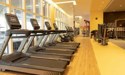 a row of tread machines in a gym at Elegant Studio Apartment with Marina View JVT in Dubai
