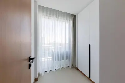 a room with a large window with white curtains at Vida Marina Residence High Floor Luxury 1 BR Flat in Dubai