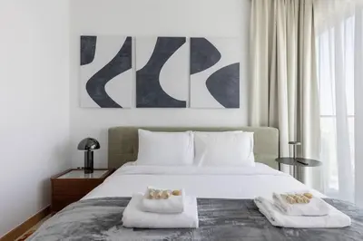 a bedroom with a bed with two towels on it at Vida Marina Residence High Floor Luxury 1 BR Flat in Dubai
