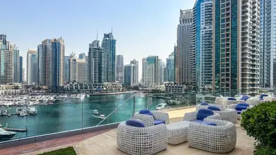 a balcony with chairs and a view of a city at Luxurious High Floor 1BDR With Full Sea View-Cayan48 in Dubai