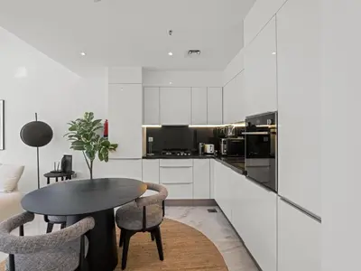 a kitchen with a table and chairs in a room at Stylish 1-Bedroom Escape The PAD Business Bay in Dubai