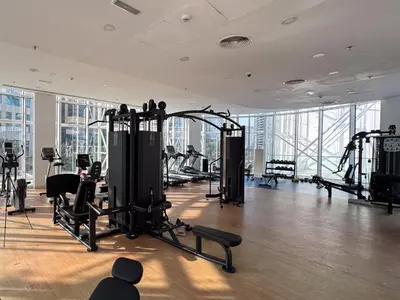 a gym with treadmills and machines in a building at Stylish 1-Bedroom Escape The PAD Business Bay in Dubai