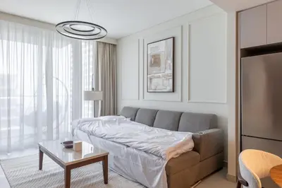 a living room with a couch and a table at Spacious 1BR at Beach Mansion Balcony, Pool and Gym in Dubai