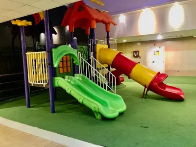a playground with a slide in a room at Beautiful newly renovated apartment in the heart of Dubai in Dubai