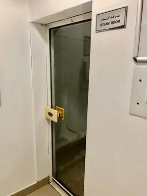an open door with a sign on a wall at Beautiful newly renovated apartment in the heart of Dubai in Dubai