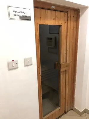 a glass door in a room with a sign on the wall at Beautiful newly renovated apartment in the heart of Dubai in Dubai