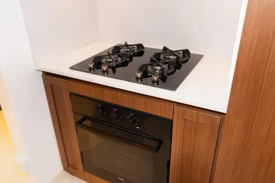 a black stove top oven in a kitchen at CitiHome - Private Beach Access - Emaar Beachfront in Dubai