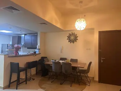 a dining room with a table and chairs at Luxury furnished bed room for VIP family in Dubai