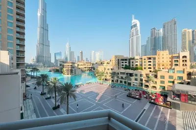 a view of a city with a river and buildings at Burj Khalifa & Fountain View - Downtown - 2BR in Dubai