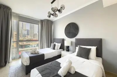 a hotel room with two beds and a window at Burj Khalifa & Fountain View - Downtown - 2BR in Dubai