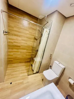 a bathroom with a toilet and a shower at Modern brand new Loft Townhouse in Dubai in Dubai
