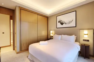 a bedroom with a large white bed in a room at 3B in Downtown with Burj Khalifa View Near Dubai Mall and Opera District in Dubai