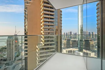 a view of a city from the balcony of a building at FIRST CLASS 2BR Marina, Sea & Ain Views in Dubai