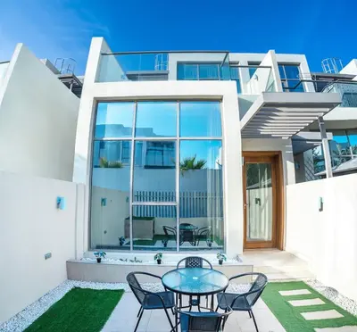 a house with a patio with a table and chairs at Executive 4BR Townhouse - Al Furjan in Dubai