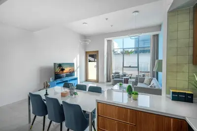 a kitchen and living room with a table and chairs at Executive 4BR Townhouse - Al Furjan in Dubai