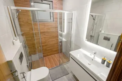 a bathroom with a shower and a toilet and a sink at Executive 4BR Townhouse - Al Furjan in Dubai