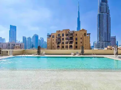 a swimming pool on the roof of a building with a city skyline at very nice apartment in Burj khalifa area downtown in Dubai