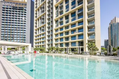 a large swimming pool in front of a building at very nice apartment in Burj khalifa area downtown in Dubai