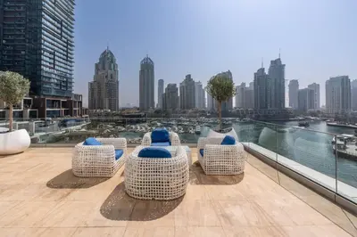 a balcony with chairs and a view of a city at Marina | Canal View Studio in Cayan Tower in Dubai