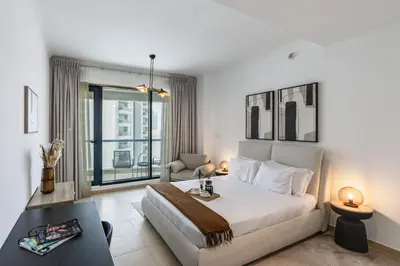 a bedroom with a large bed and a window at Modern Comfort - Convenient - Prime JLT Living in Dubai