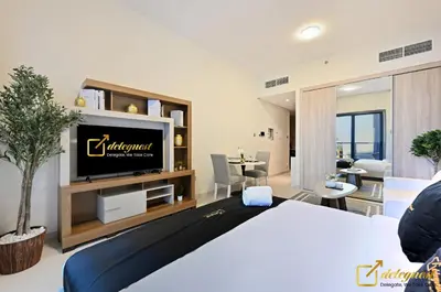 a bedroom with a bed and a tv in a room at Luxury Studio in Dubai Hills by Deleguest in Dubai