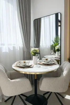 a dining room table with chairs and a mirror at Luxury 1BR W Private Pool Binghatti Royale in Dubai