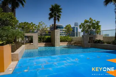 a swimming pool with a city skyline in the background at Elegant Studio Living in Privé in Dubai
